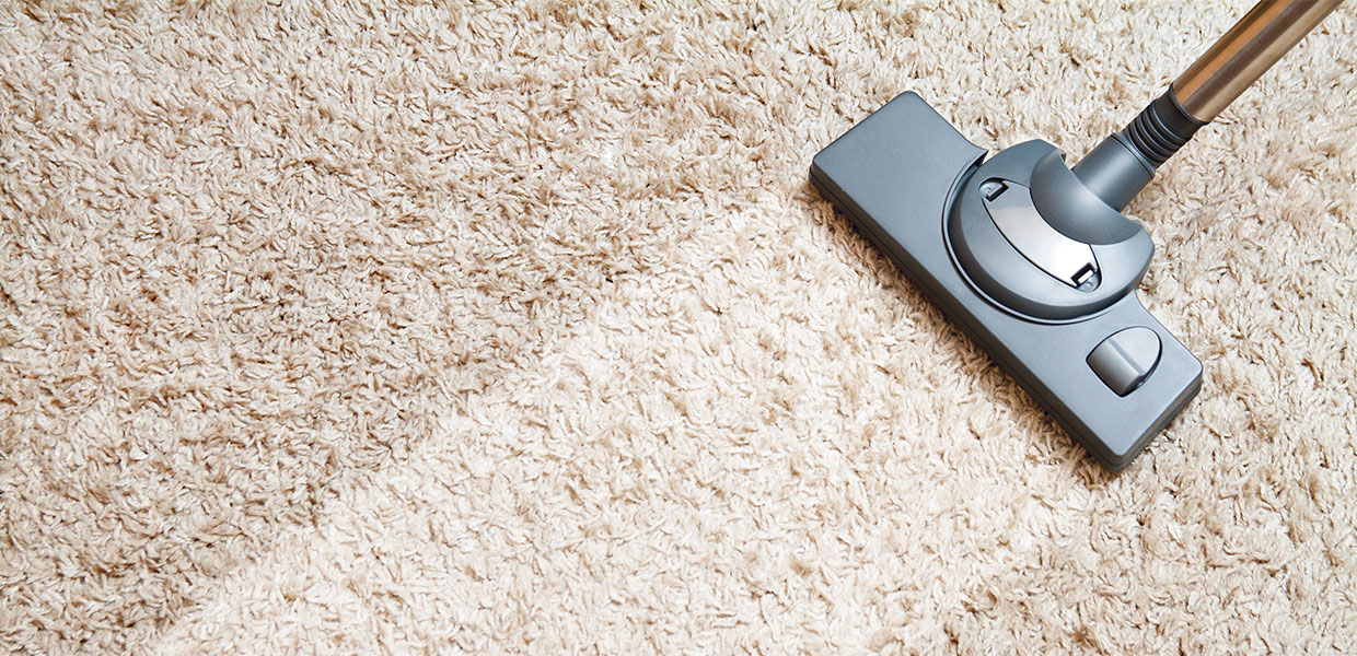 A remote control sitting on top of a carpet.